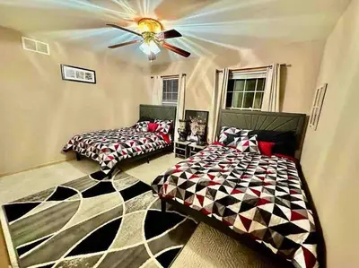a bedroom with two beds and a ceiling fan at Cheerful 5-bedroom resort with heated pool in East Stroudsburg