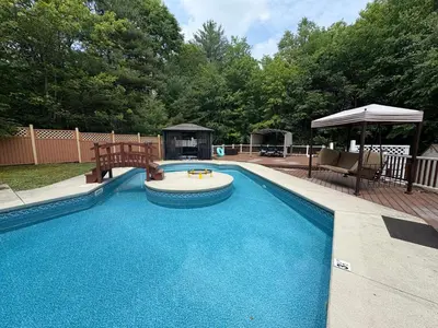 a swimming pool in a yard with at Cheerful 5-bedroom resort with heated pool in East Stroudsburg
