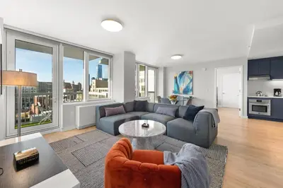 a living room with a couch and a table at Synergy Chelsea in New York