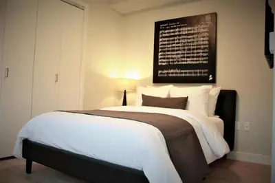 a bedroom with a large bed with a black and white blanket at Synergy Chelsea in New York