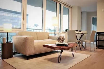 a living room with a couch and a table at Synergy Chelsea in New York
