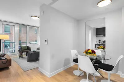 a living room with a table and chairs at Synergy Chelsea in New York