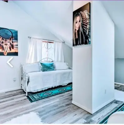 a bedroom with a bed with a poster on the wall at Majesty mountains The Great spirit of Wakan Tanka in Vernon Township