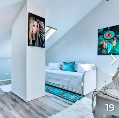 a white room with a bed and a picture on the wall at Majesty mountains The Great spirit of Wakan Tanka in Vernon Township