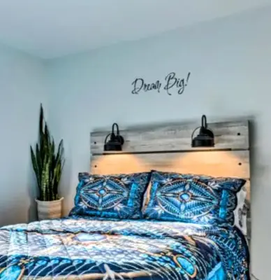 a bedroom with a bed with a sign that reads dream pier at Majesty mountains The Great spirit of Wakan Tanka in Vernon Township