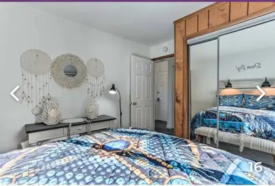 a bedroom with a bed and a large mirror at Majesty mountains The Great spirit of Wakan Tanka in Vernon Township
