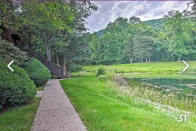 a walkway next to a lake in a park at Majesty mountains The Great spirit of Wakan Tanka in Vernon Township