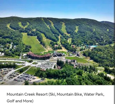 an aerial view of a mountain gist resort gist mountain bike and water park at Majesty mountains The Great spirit of Wakan Tanka in Vernon Township