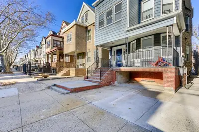 a row of houses on a city street at Jersey City Vacation Rental Near Light Rail! in Jersey City