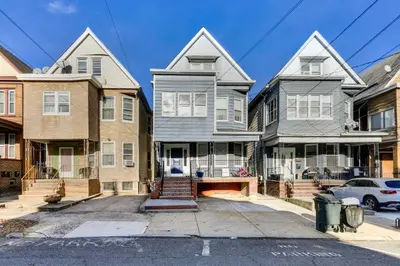 a row of houses on a city street at Jersey City Vacation Rental Near Light Rail! in Jersey City