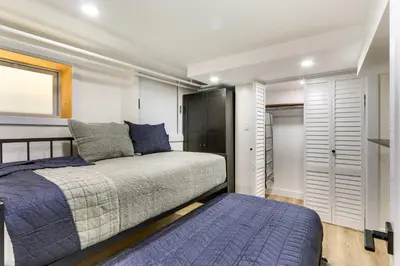 a bedroom with a bed and a closet at Jersey City Vacation Rental Near Light Rail! in Jersey City