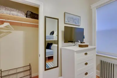 a bedroom with a mirror and a white dresser at Jersey City Apartment Near Liberty State Park in Jersey City