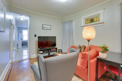 a living room with a red couch and a television at Jersey City Apartment Near Liberty State Park in Jersey City