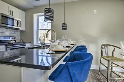 a kitchen with blue velvet chairs and a table at Newark Rental Near University of Delaware! in Newark