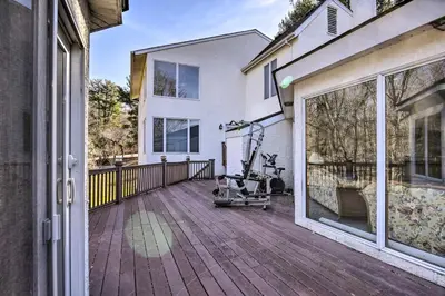 a house with a wooden deck with a large window at Newark Rental Near University of Delaware! in Newark