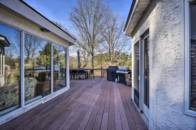 a wooden deck with a table and chairs on a house at Newark Rental Near University of Delaware! in Newark