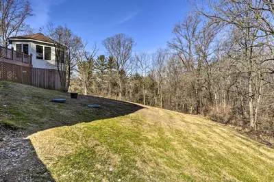 a house on top of a grassy hill at Newark Rental Near University of Delaware! in Newark