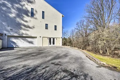 a large white building with a garage at Newark Rental Near University of Delaware! in Newark