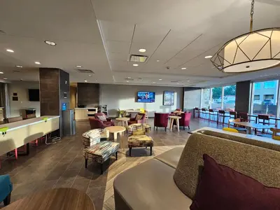 a lobby with couches and tables and a pool table at Home2 Suites By Hilton Allentown Bethlehem Airport in Bethlehem