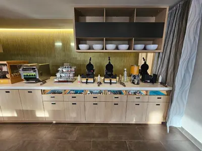a kitchen with a counter with food on it at Home2 Suites By Hilton Allentown Bethlehem Airport in Bethlehem