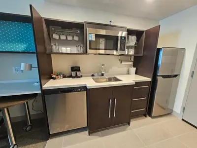a small kitchen with a sink and a refrigerator at Home2 Suites By Hilton Allentown Bethlehem Airport in Bethlehem