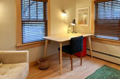 a desk in a room with a chair and windows at Hÿgge House in Margaretville