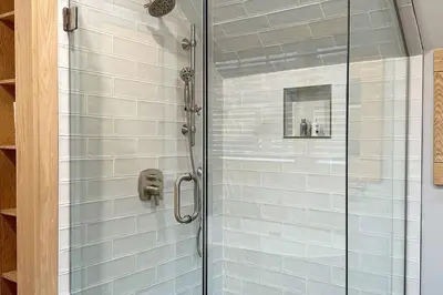 a shower with a glass door in a bathroom at Hÿgge House in Margaretville