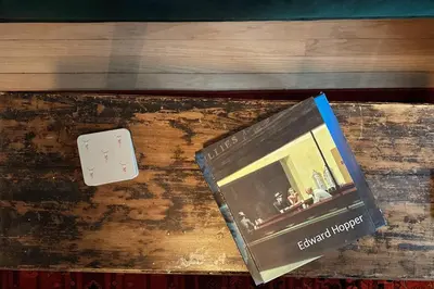 a book sitting on top of a wooden table at Hÿgge House in Margaretville