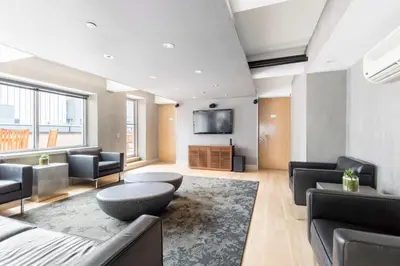 a living room with furniture and a flat screen tv at Tribeca 1BR w Gym Doorman Valet NYC-51 in New York