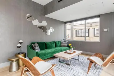a living room with a green couch and a table at Tribeca 1BR w Gym Doorman Valet NYC-51 in New York