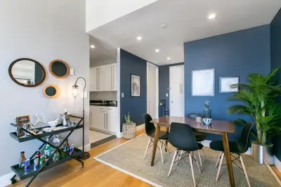 a dining room with blue walls and a table and chairs at Tribeca 1BR w Gym Doorman Valet NYC-51 in New York