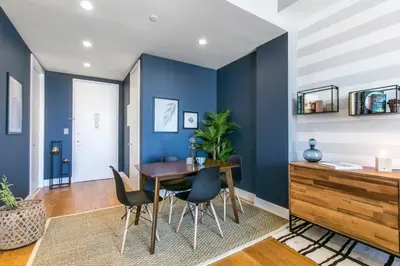 a dining room with blue walls and a table and chairs at Tribeca 1BR w Gym Doorman Valet NYC-51 in New York