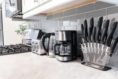 a kitchen counter with a coffee maker and utensils at 39-2 Renovated 3BR Prime Hudson Yards Area in New York