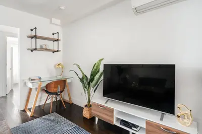 a living room with a large flat screen tv at 39-2 Renovated 3BR Prime Hudson Yards Area in New York
