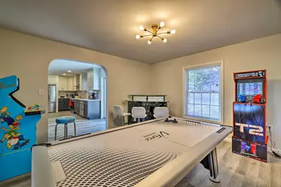a living room with a large pool table in it at Movie Room, Hot Tub Pocono Vacation Rental! in East Stroudsburg