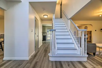 a white staircase in a home with blue treads at Movie Room, Hot Tub Pocono Vacation Rental! in East Stroudsburg