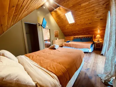 a bedroom with two beds and a wooden ceiling at Knoll by the Lake-7 minutes to skiing in Lake Harmony