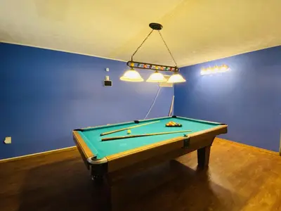 a pool table in a room with blue walls at Knoll by the Lake-7 minutes to skiing in Lake Harmony