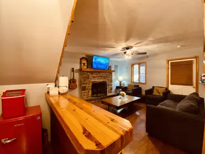 a living room with a couch and a fireplace at Knoll by the Lake-7 minutes to skiing in Lake Harmony
