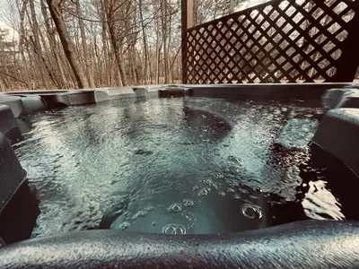 a hot tub in the middle of the woods at Knoll by the Lake-7 minutes to skiing in Lake Harmony