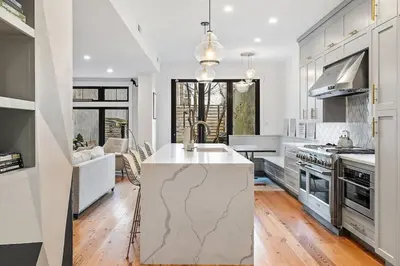 a kitchen with a large island in the middle at Designer 3 BR Townhome with Beautiful Backyard in Philadelphia