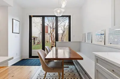 a kitchen with a table and chairs and a window at Designer 3 BR Townhome with Beautiful Backyard in Philadelphia