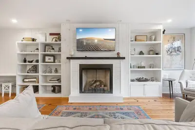 a living room with a fireplace and a tv at Designer 3 BR Townhome with Beautiful Backyard in Philadelphia