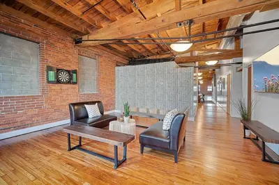 a living room with furniture and a brick wall at World Cup 2026 Luxury Industrial Loft in Philadelphia
