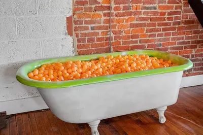 a bath tub filled with lots of oranges at World Cup 2026 Luxury Industrial Loft in Philadelphia