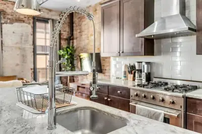 a kitchen with a sink and a stove at The Independence Suite Residence in Philadelphia