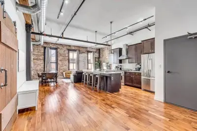 an open kitchen and living room with a hard wood floor at The Independence Suite Residence in Philadelphia