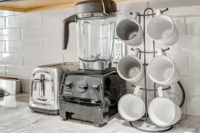 a kitchen with a blender and some plates and pans at The Independence Suite Residence in Philadelphia
