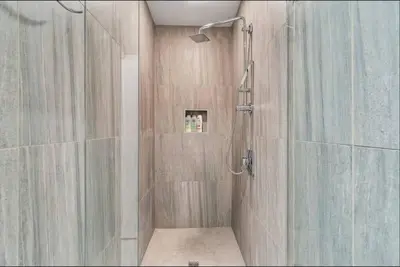 a bathroom with a shower with a shower curtain at The Independence Suite Residence in Philadelphia