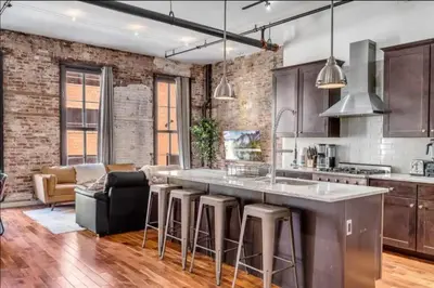 a kitchen with a bar and a living room at The Independence Suite Residence in Philadelphia